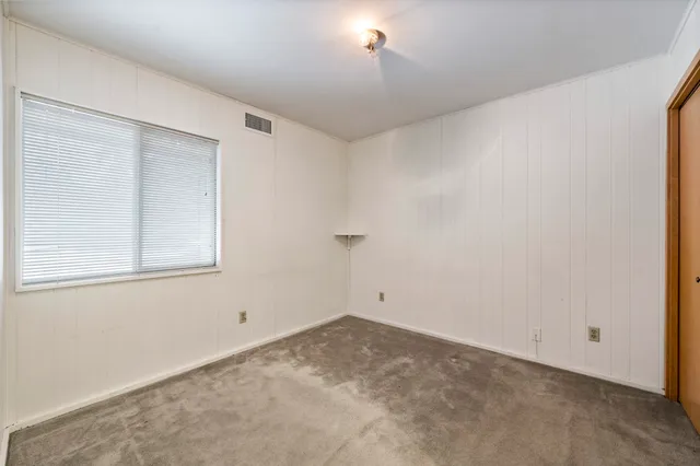 a patio with a table and chairs under an umbrella