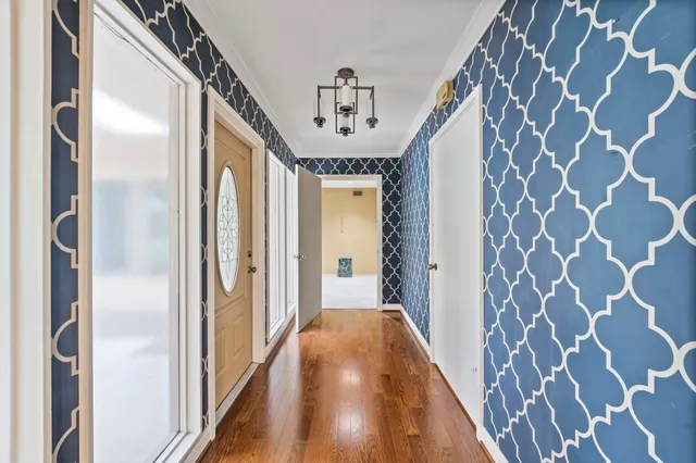 a view of a hallway with a door and windows