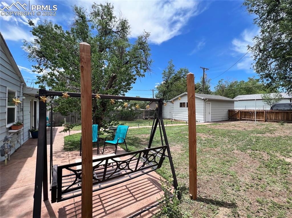 814 Sunset Road Colorado Springs, CO 80909 - Photo 20 of 29 a view of a deck with a table chairs and a backyard