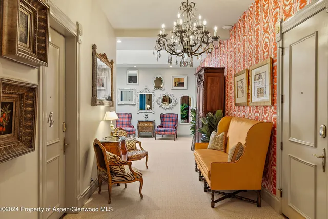 a front view of a building with lot of cars and trees