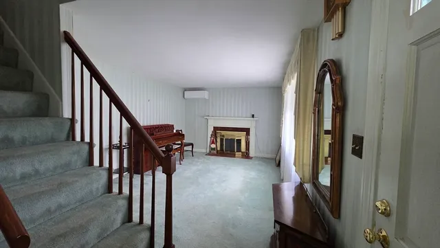 a view of a livingroom with furniture and staircase