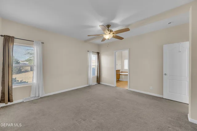 a front view of a house with a garden and mountain view