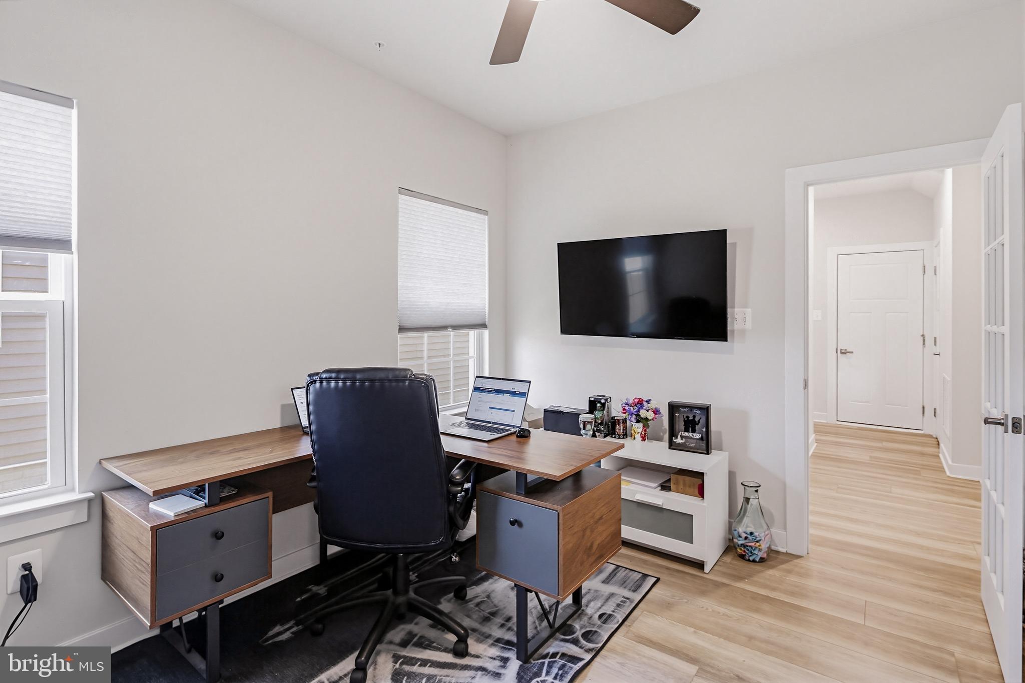 3172 Dodder Way Odenton, MD 21113 - Photo 19 of 59 a view of a workspace with furniture and a flat screen tv