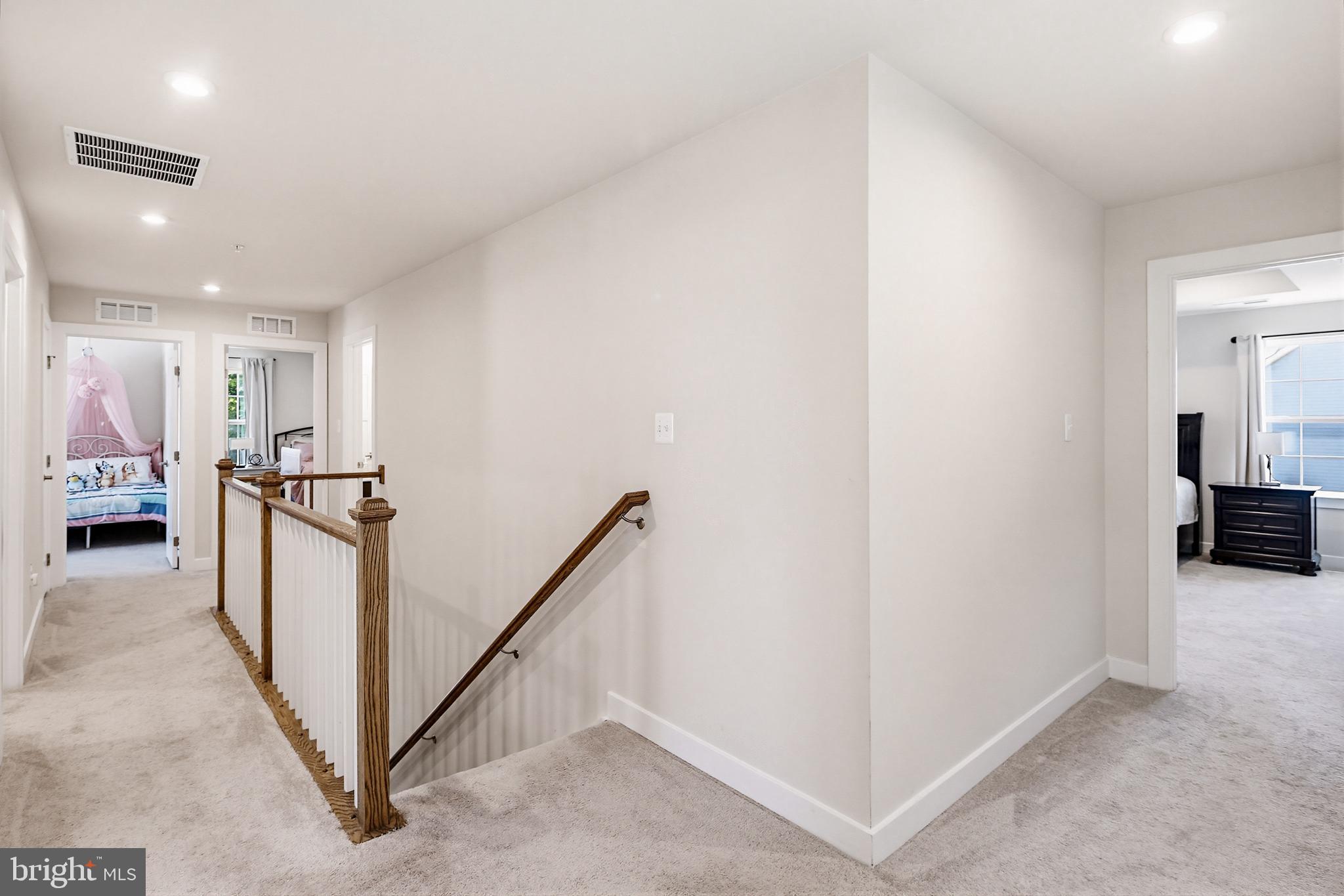 3172 Dodder Way Odenton, MD 21113 - Photo 22 of 59 a view of a hallway with a white stove and a refrigerator
