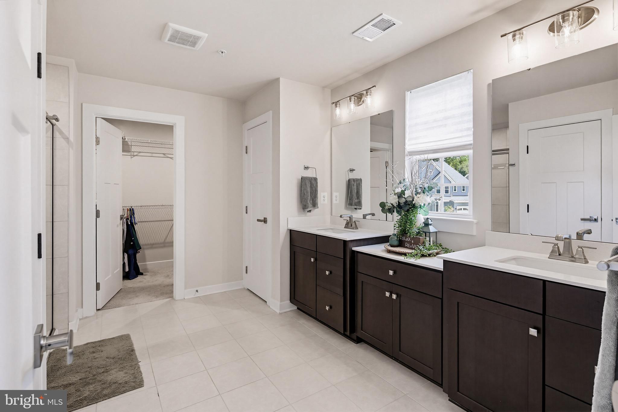 3172 Dodder Way Odenton, MD 21113 - Photo 27 of 59 a spacious bathroom with a double vanity sink mirror and shower