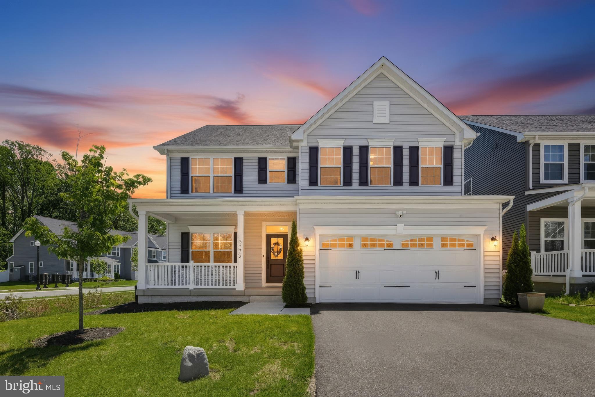 3172 Dodder Way Odenton, MD 21113 - Photo 51 of 59 a front view of a house with a yard and garage