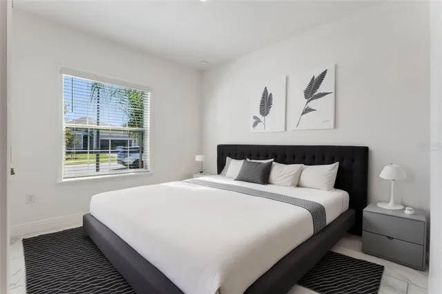 a bedroom with bed and window