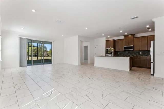 a view of a kitchen with a sink and microwave