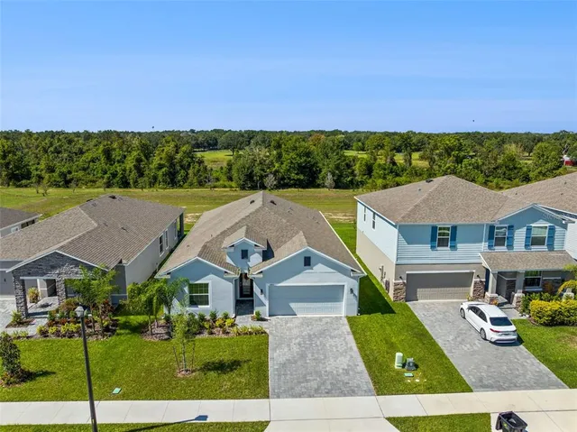 an aerial view of a house with a yard