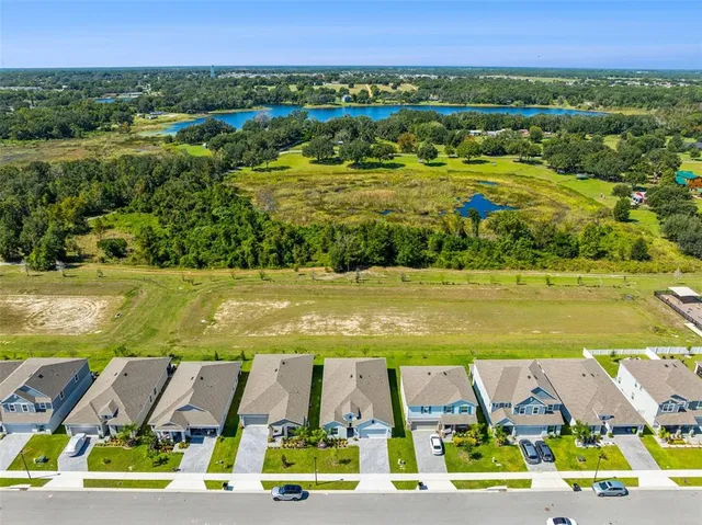 an aerial view of residential houses with outdoor space and swimming pool