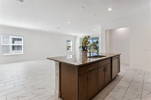 a kitchen with stainless steel appliances granite countertop a sink and a granite counter tops