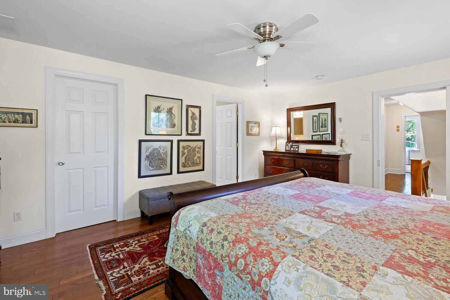 7 Walt Lane Wyncote, PA 19095 - Photo 18 of 44 a bedroom with a large bed and a chandelier