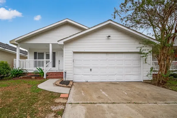 a front view of house with backyard and trees