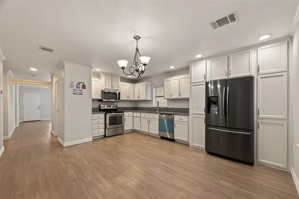 a kitchen with a refrigerator and a sink