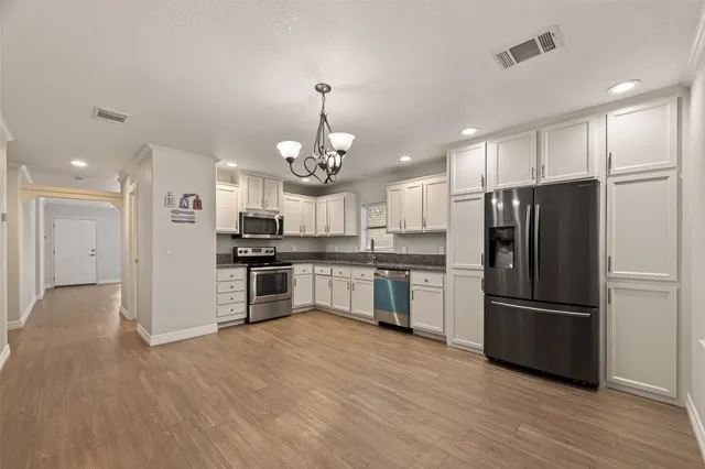 a kitchen with a refrigerator and a sink