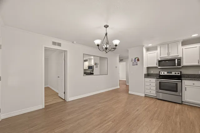 a view of a kitchen with a sink a refrigerator and window