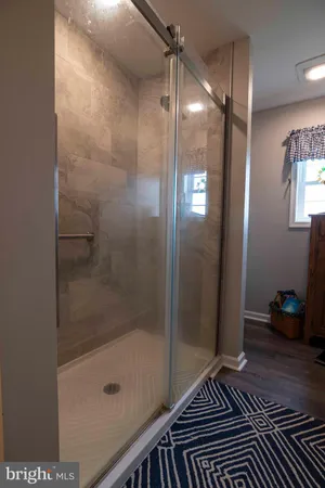 a bathroom with a glass shower door