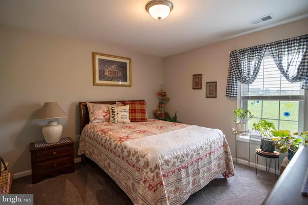 a bedroom with bed and wooden floor