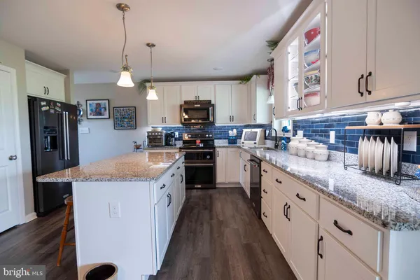 a kitchen with a refrigerator and a stove