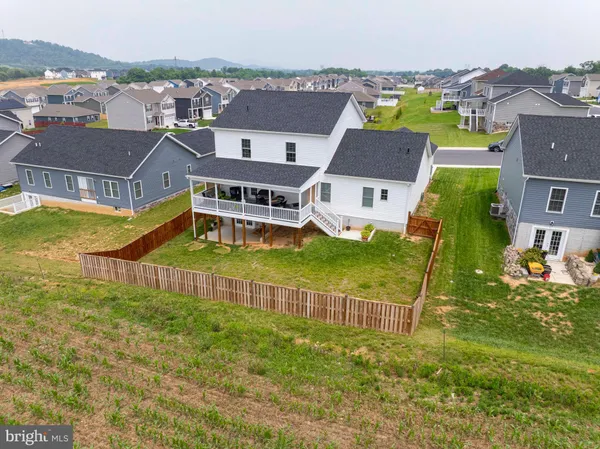 an aerial view of residential houses with outdoor space and swimming pool