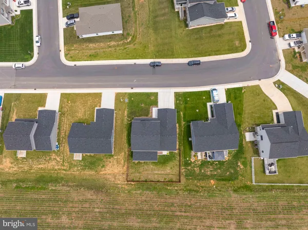 a aerial view of a house with a swimming pool and a yard