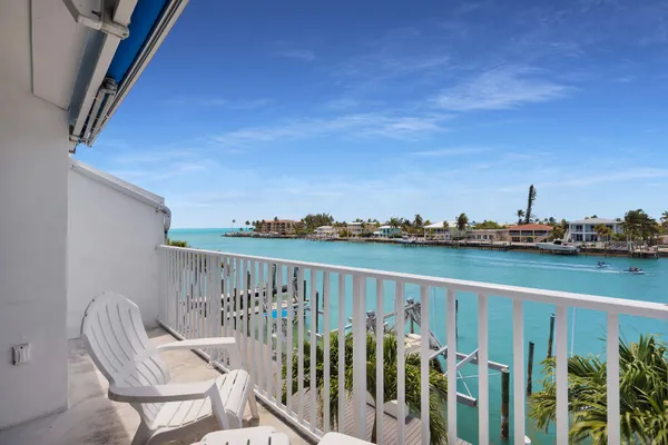 a view of a balcony with chairs