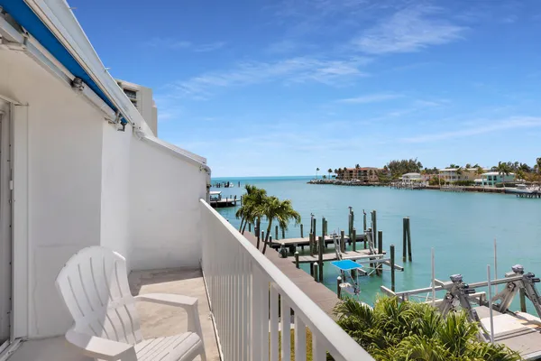 a view of a balcony with an outdoor seating