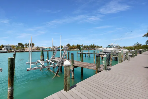 a couple of chairs sitting in a roof deck with a lake view