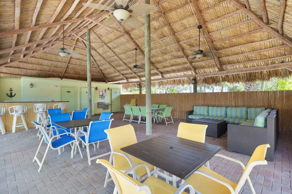 a view of a patio with a dining table and chairs with wooden floor