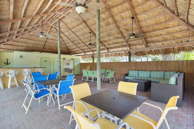 a view of a patio with a dining table and chairs with wooden floor
