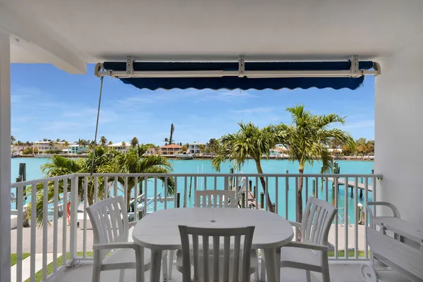 a view of a balcony dining table and chairs