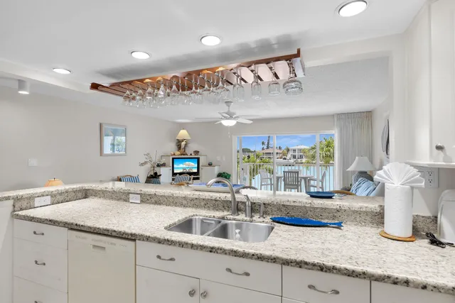 a bathroom with a granite countertop sink and a large mirror