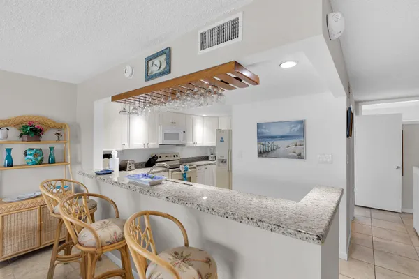 a living room with granite countertop furniture and a dining table