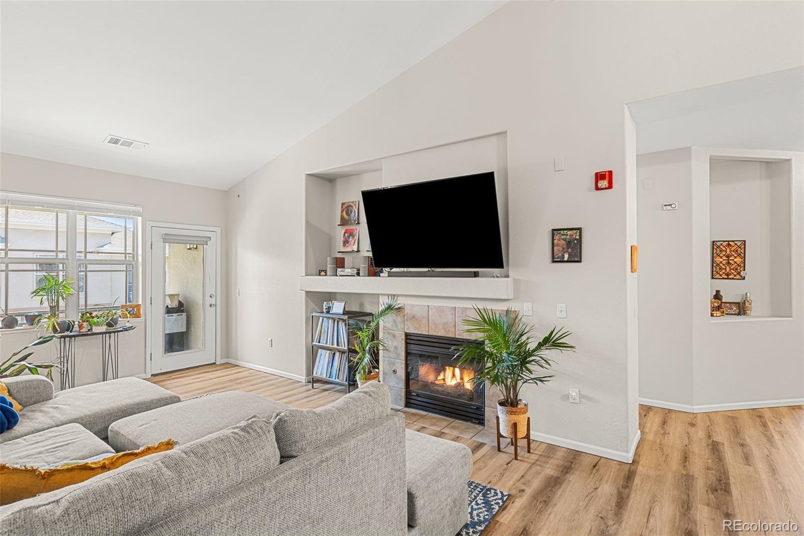 8073 West 51st Place, Unit 303 Arvada, CO 80002 - Photo 1 of 48 a living room with furniture and a flat screen tv