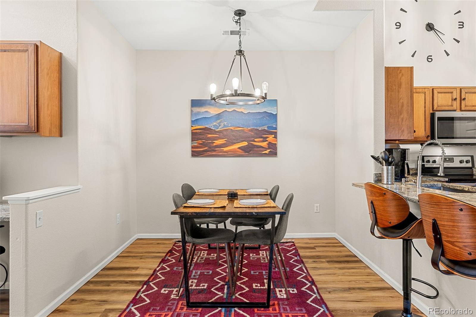 8073 West 51st Place, Unit 303 Arvada, CO 80002 - Photo 17 of 48 a view of a room with furniture and wooden floor