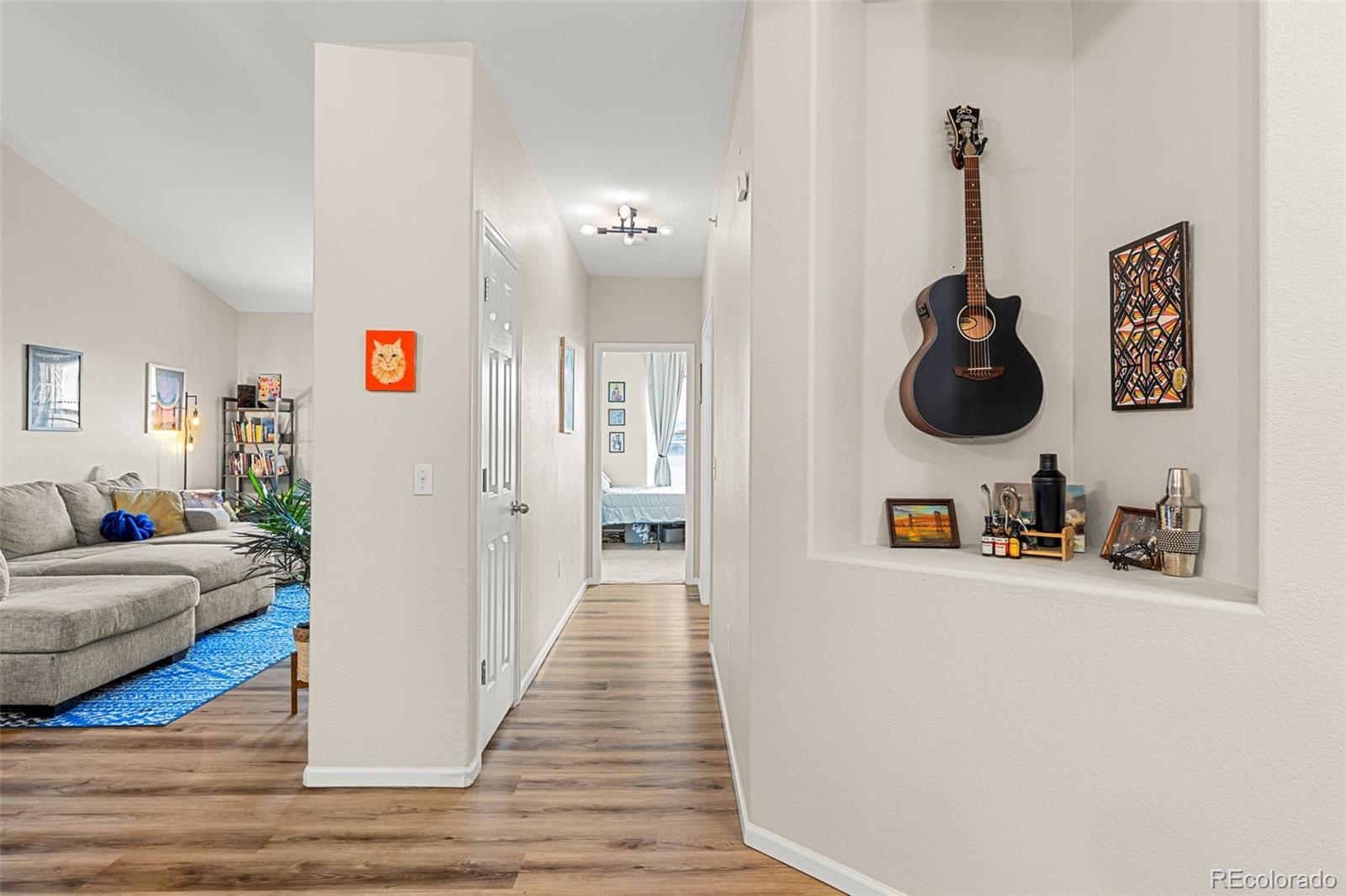 8073 West 51st Place, Unit 303 Arvada, CO 80002 - Photo 20 of 48 a living room with furniture and a wooden floor