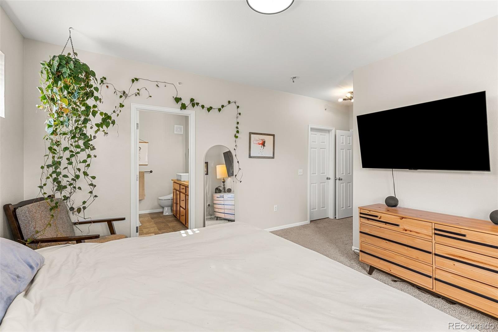 8073 West 51st Place, Unit 303 Arvada, CO 80002 - Photo 26 of 48 a bedroom with a bed and a flat screen tv