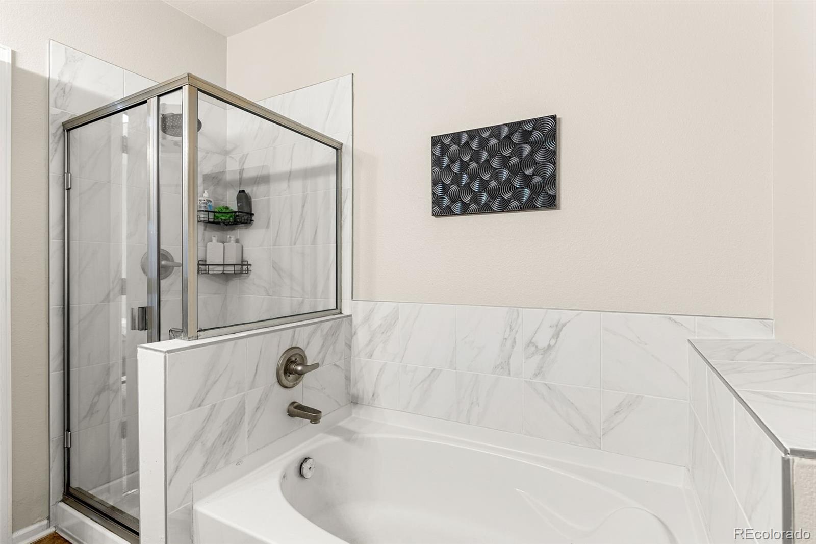 8073 West 51st Place, Unit 303 Arvada, CO 80002 - Photo 31 of 48 a bathroom with a bathtub and a shower