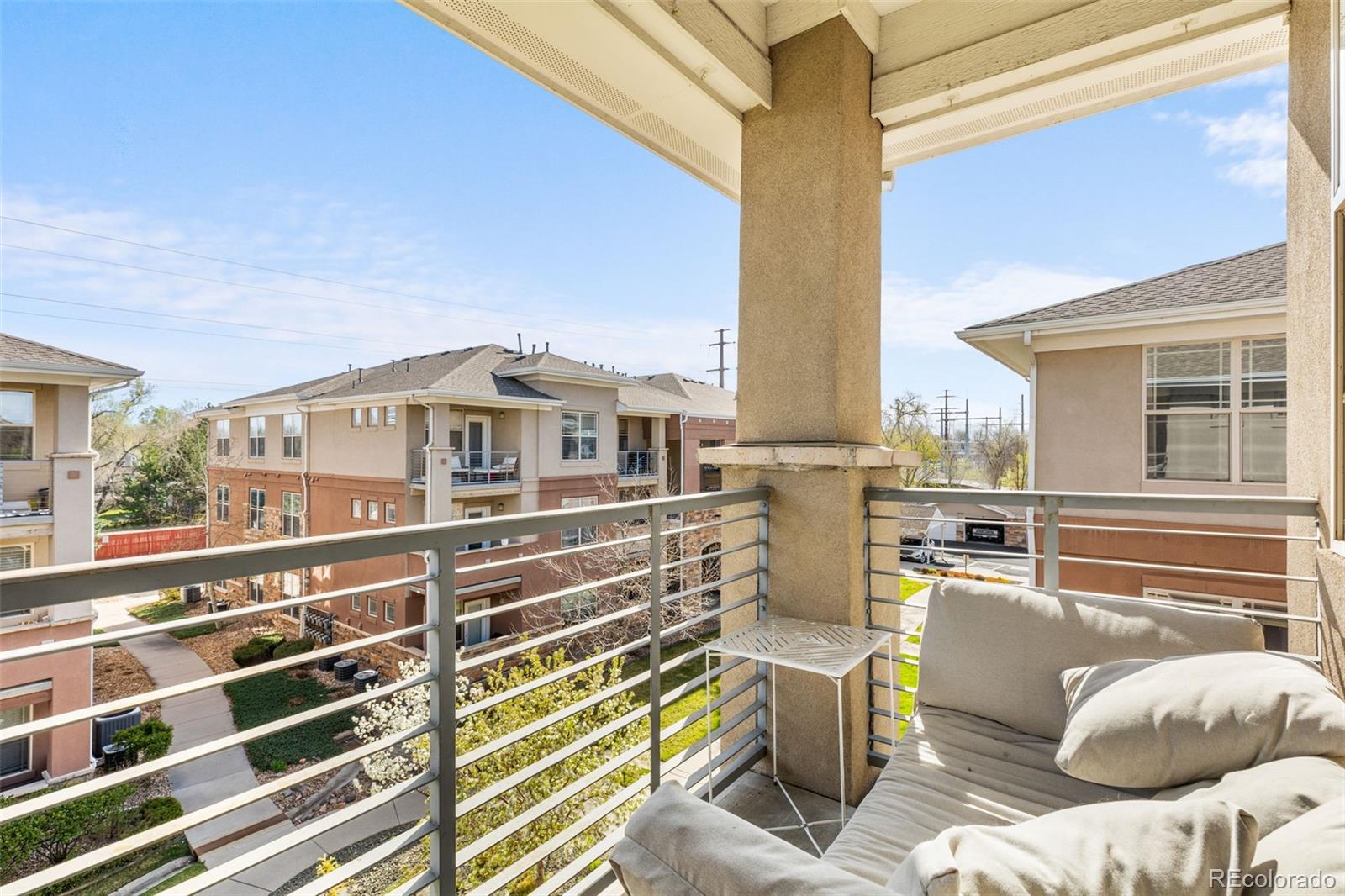 8073 West 51st Place, Unit 303 Arvada, CO 80002 - Photo 33 of 48 a view of a patio with couches chairs and wooden floor