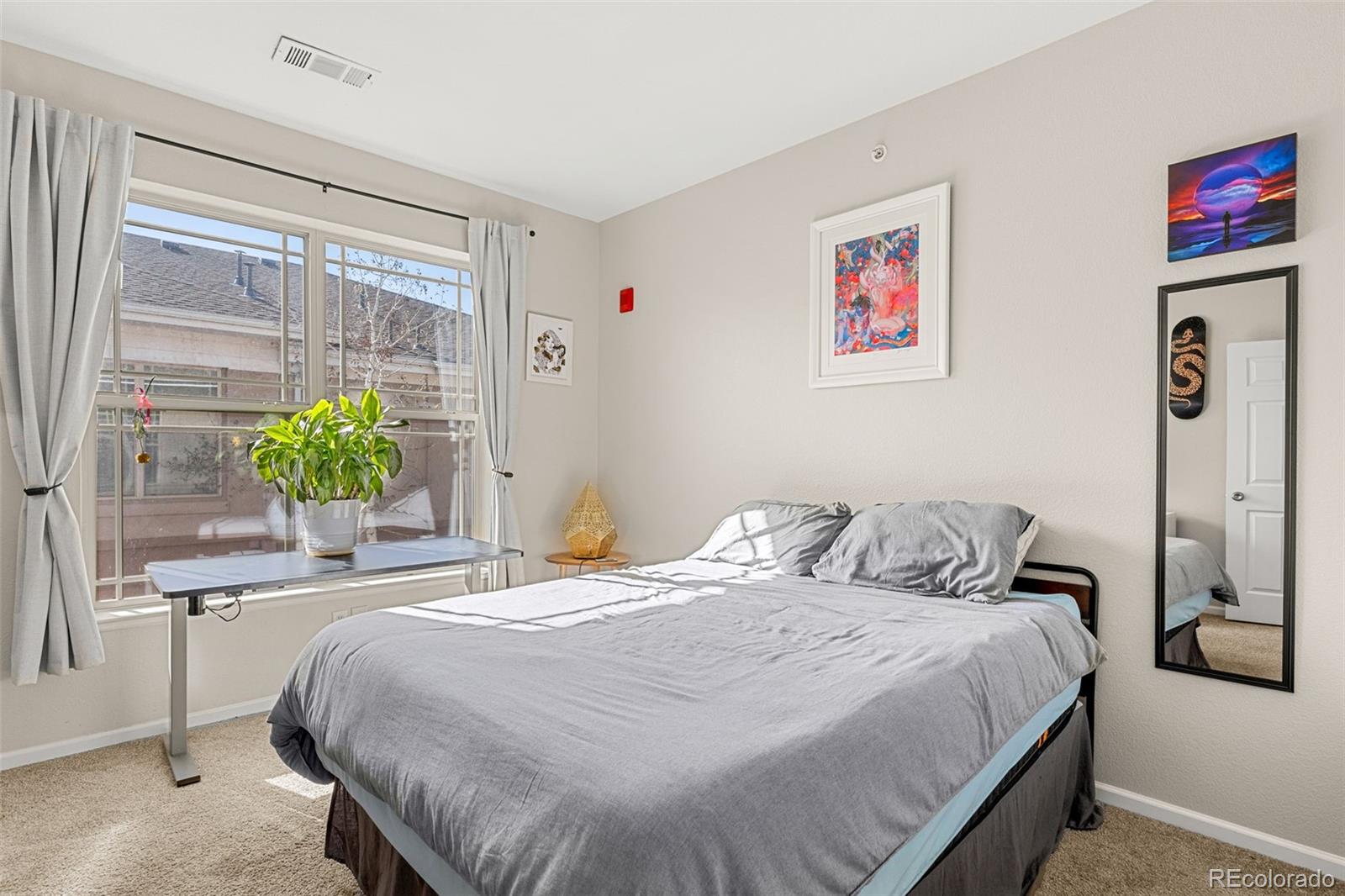 8073 West 51st Place, Unit 303 Arvada, CO 80002 - Photo 38 of 48 a bedroom with a bed and a large window