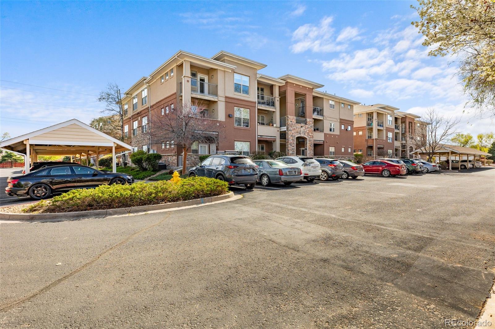 8073 West 51st Place, Unit 303 Arvada, CO 80002 - Photo 43 of 48 a city street lined with buildings and cars