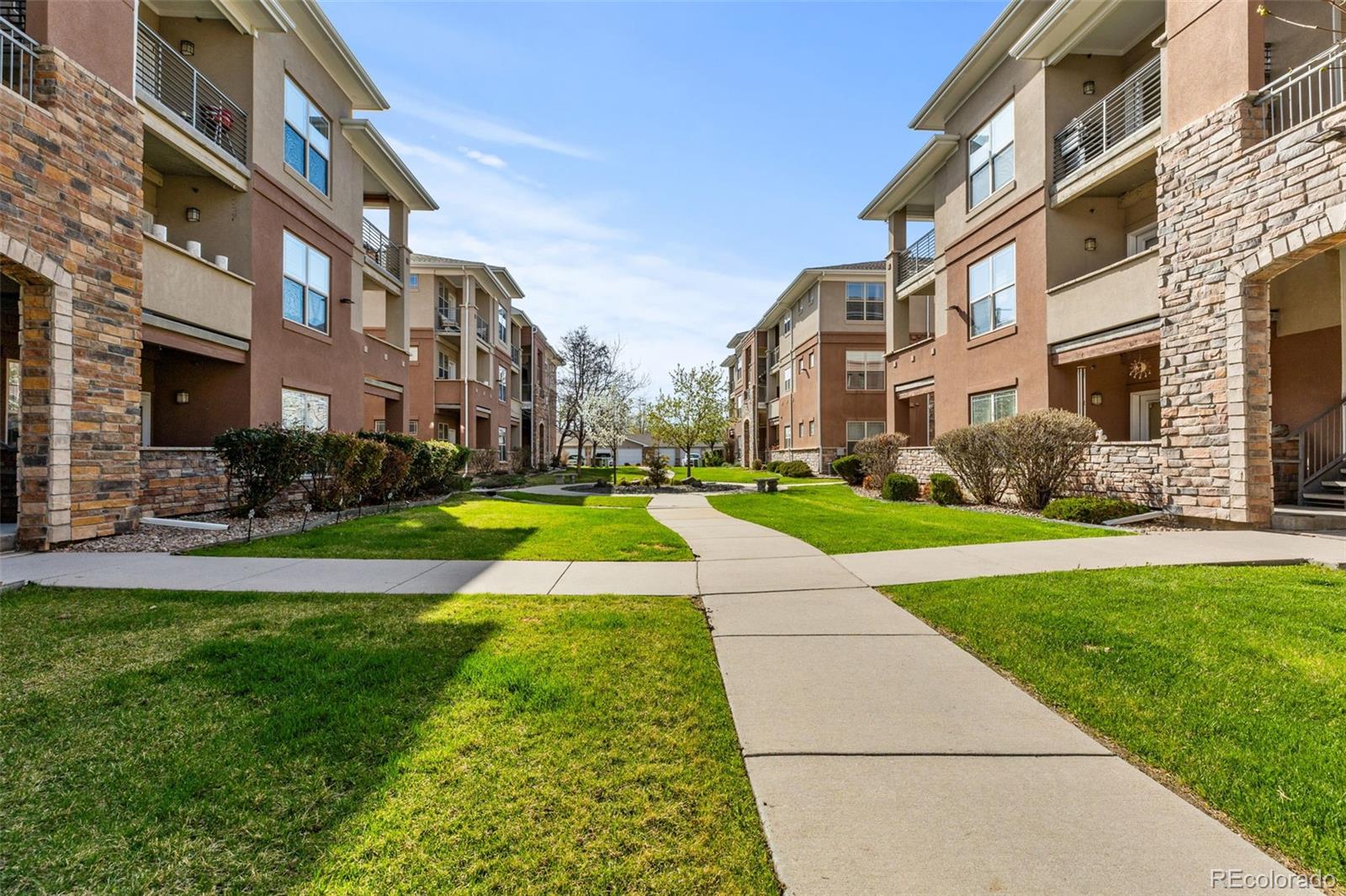 8073 West 51st Place, Unit 303 Arvada, CO 80002 - Photo 44 of 48 a view of a building with a yard