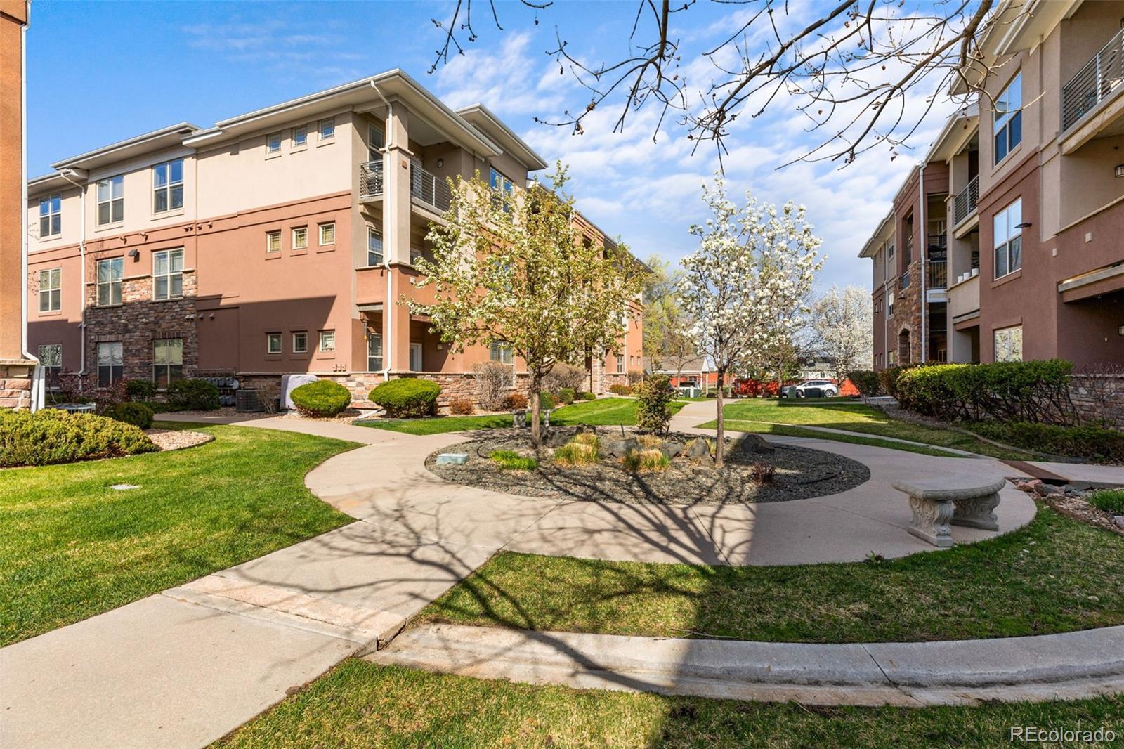 8073 West 51st Place, Unit 303 Arvada, CO 80002 - Photo 45 of 48 a view of a building with a yard