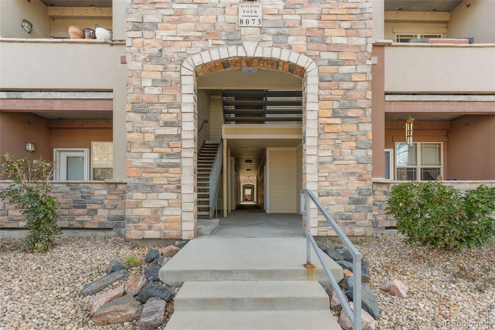 8073 West 51st Place, Unit 303 Arvada, CO 80002 - Photo 47 of 48 a front view of a house with large windows