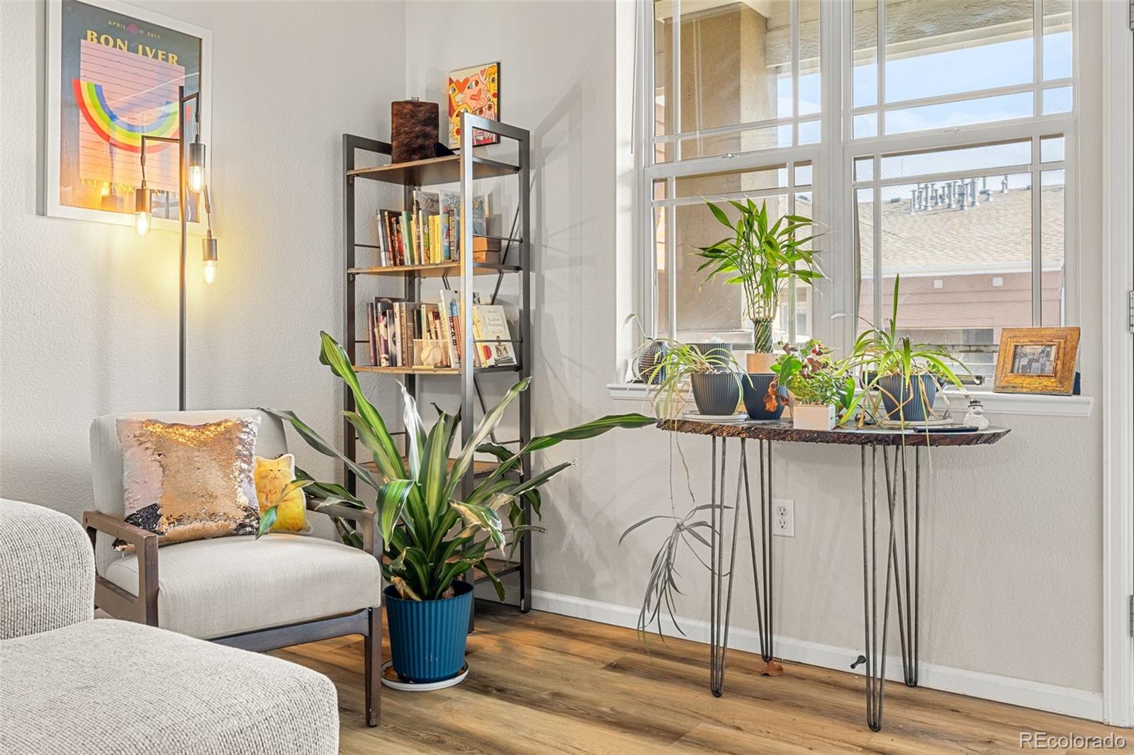 8073 West 51st Place, Unit 303 Arvada, CO 80002 - Photo 7 of 48 a living room with furniture flowerpot and wooden floor