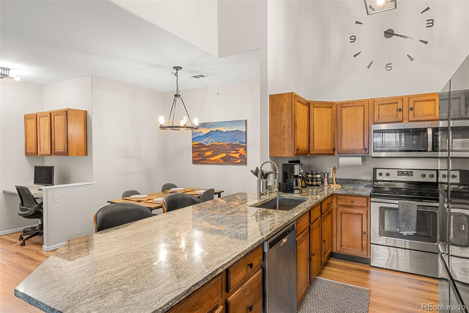 8073 West 51st Place, Unit 303 Arvada, CO 80002 - Photo 10 of 48 a kitchen with stainless steel appliances granite countertop a sink dishwasher stove and oven