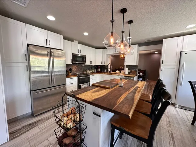 a bedroom with a bed and a dresser next to a window