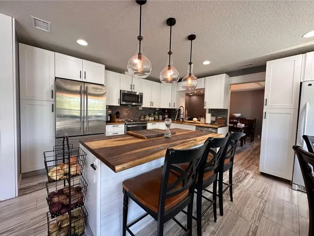 a bathroom with a sink a toilet a mirror and shower
