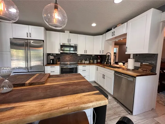 a bathroom with a granite countertop toilet sink and a shower