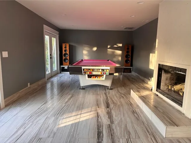 a kitchen with stainless steel appliances granite countertop a stove a refrigerator a kitchen island a table and chairs